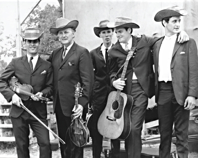 From the Archives: Left to Right: Gene Lowinger, Bill Monroe, Lamar Grier, Peter Rowan and James Monroe. Photo by Ron Petronko.